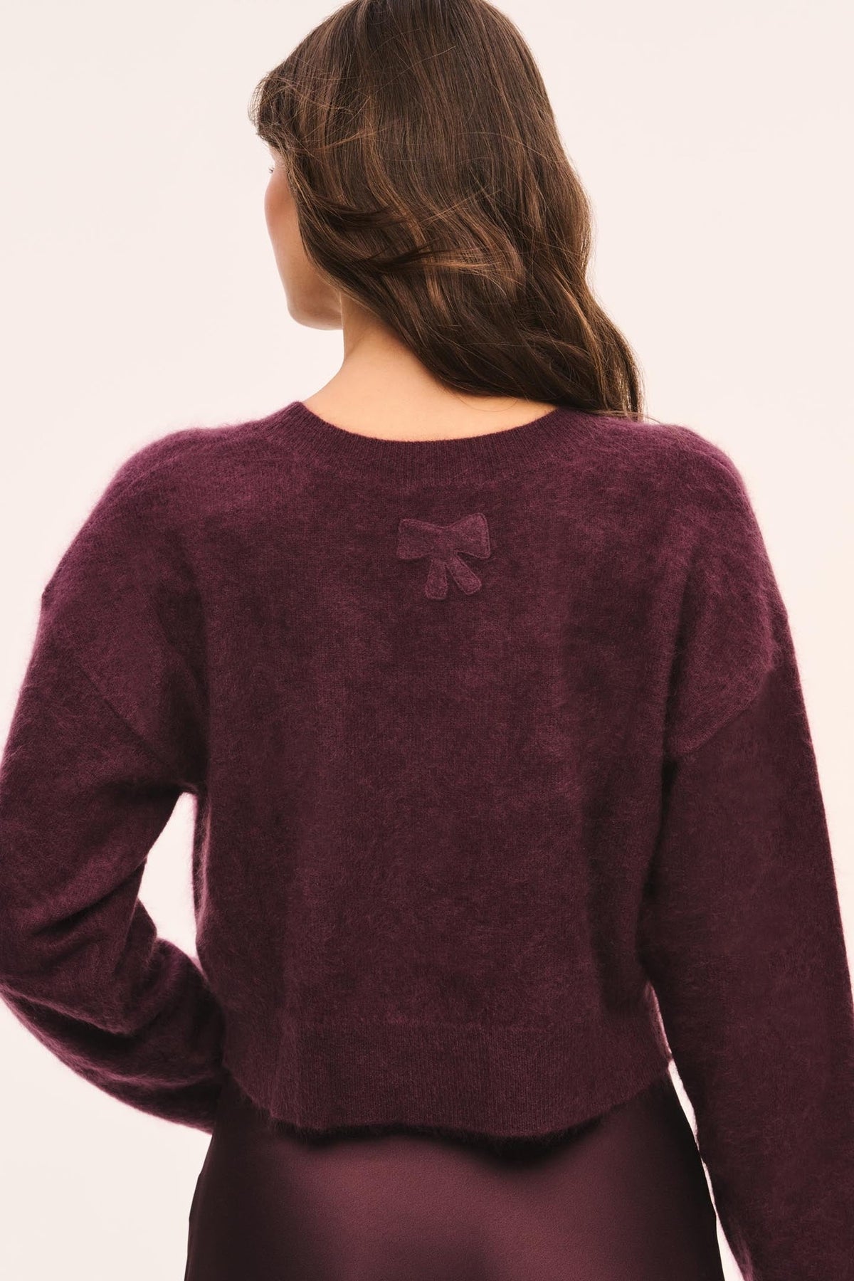 LoveShackFancy Bellaman Pullover in merlot, back view on model